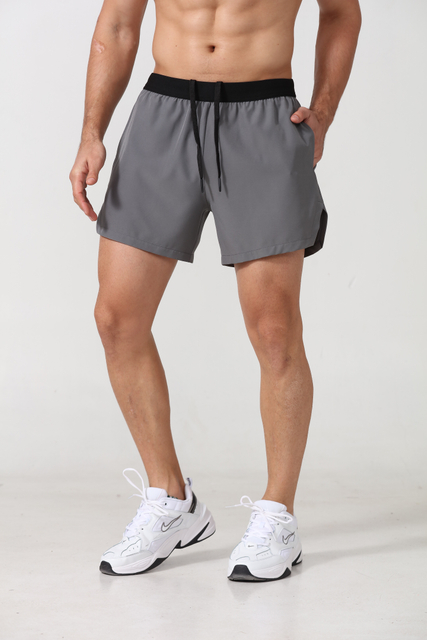 Pantalones cortos deportivos para hombres de poliéster seco rápido con bolsillos laterales Fitness entrenamiento deportivo gimnasio pantanes pantalones cortos de jogger